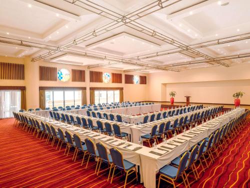 a large room with rows of tables and chairs at Mövenpick Hotel & Residences Nairobi in Nairobi