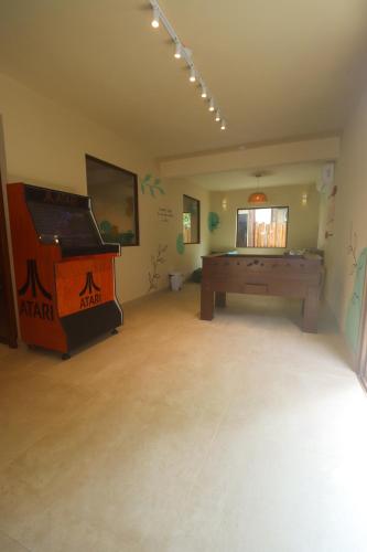 a room with a pool table and a piano at Pousada Caiçara in Abraão