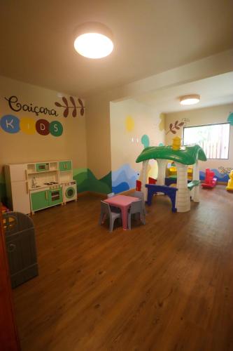 a childs play room with a play table and a slide at Pousada Caiçara in Abraão