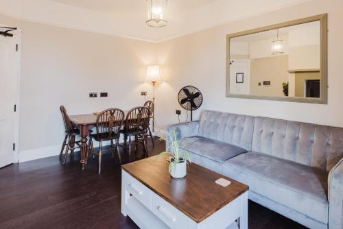 a living room with a couch and a table at Grace's Guesthouse The Suite Room 6 in Tring