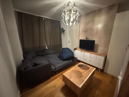 a living room with a couch and a table at The Cozy Double Retreat in London
