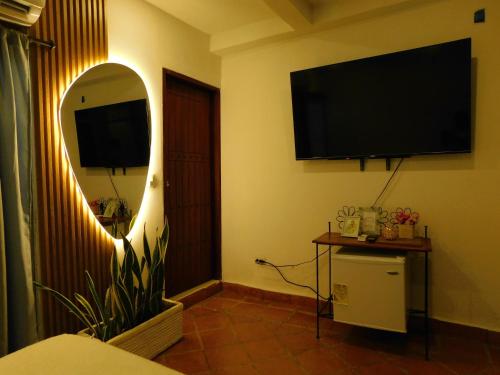 a living room with a flat screen tv on the wall at La casa del Colibri in Mompos