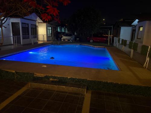 a swimming pool at night with blue illumination at Hotel Cecil in Vallenar