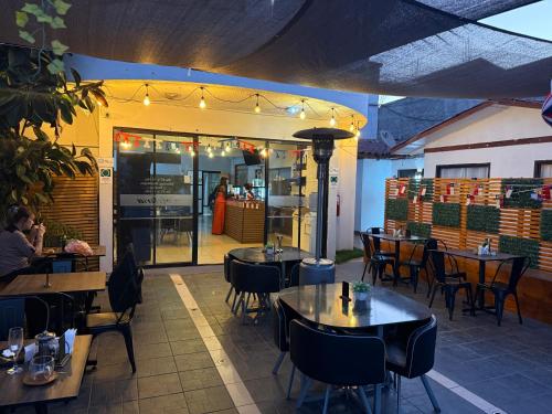 a restaurant with tables and chairs in front of it at Hotel Cecil in Vallenar