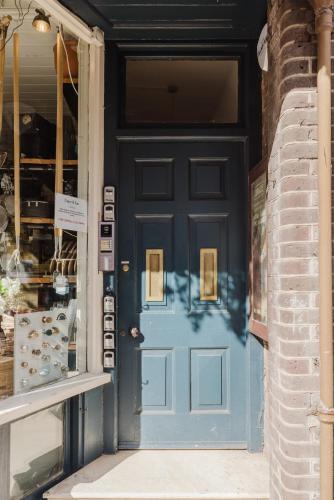 a blue front door of a store at Grace's Guesthouse Room 3 in Tring