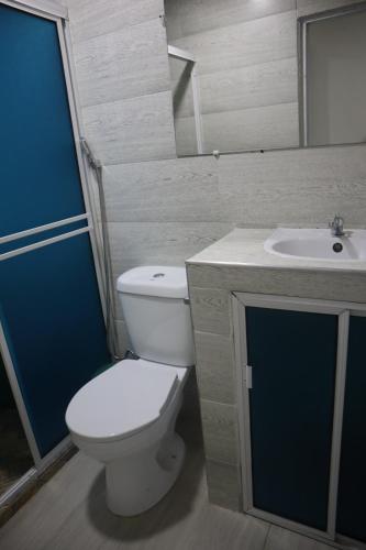a bathroom with a toilet and a sink at Penthouses La Fe in Cartagena de Indias