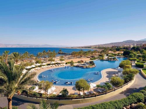 an aerial view of a resort with a pool at Mövenpick Resort & Spa Tala Bay Aqaba in Aqaba