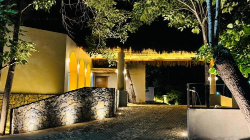 a building with a tree in front of a street at Hotel Hacienda de Melaque in San Patricio Melaque