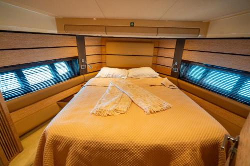 a bed in the middle of a room with two windows at Azimut 58 in Panama City
