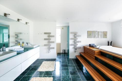a bathroom with two sinks and a bath tub at Denmark NN Scandinavian Villa Escape by the Sea in Solrød Strand