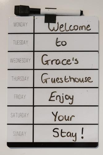a sign with the words welcome to greece and a clipboard at Grace's Guesthouse 68a in Tring