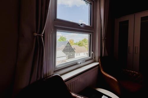 a window with a view of a house at Grace's Guesthouse 68a in Tring