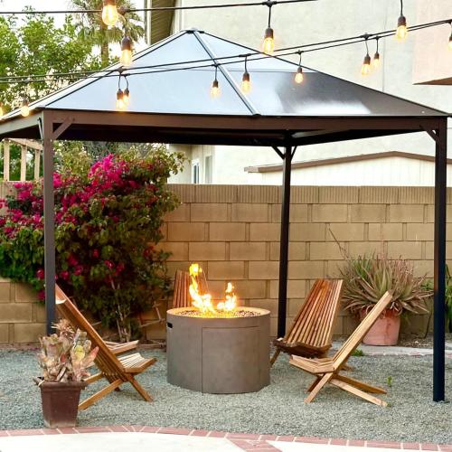 a black canopy with two chairs and a fire pit at CA3 House Spacious SoCal Home for Groups in La Palma