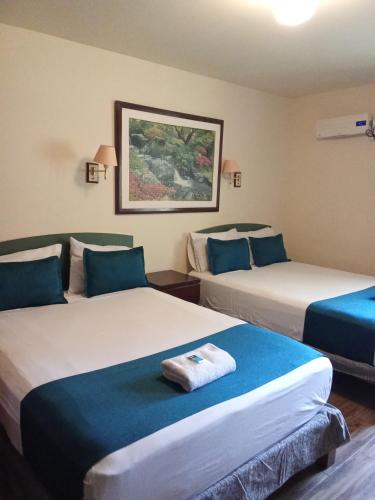Postel nebo postele na pokoji v ubytování Hotel San Isidro Inn