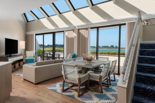 a living room with a couch and a table with chairs at San Diego Mission Bay Resort in San Diego