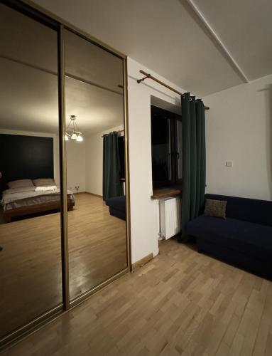 a large mirror in a room with a bedroom at Hotel Familiar in Kobyłka