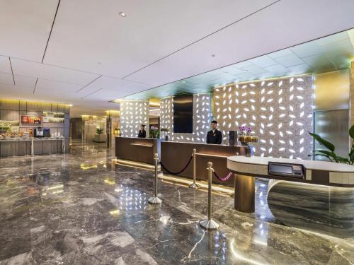 a lobby of a hotel with a bar in it at Novotel Xi'an The Bell Tower in Xi'an