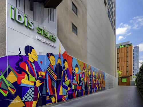 a mural on the side of a building at ibis Styles Bangkok Silom in Bangkok