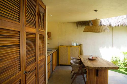 a kitchen with a wooden table and a wooden cabinet at Villa Yahualli - Alberca Privada - Punta Pérula in Pérula