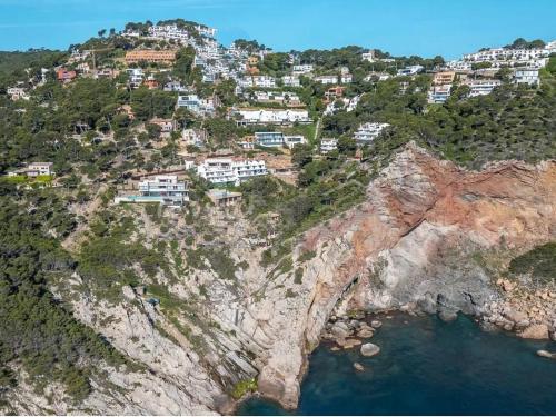 an aerial view of a mountain with houses on a cliff at "Belvédère de la Mer" Résidence "Icaros" Wifi-Piscine-Pkg in Begur