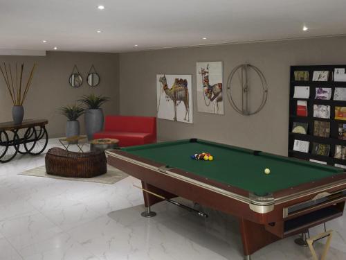 a living room with a pool table in it at ibis Jeddah City Center in Jeddah