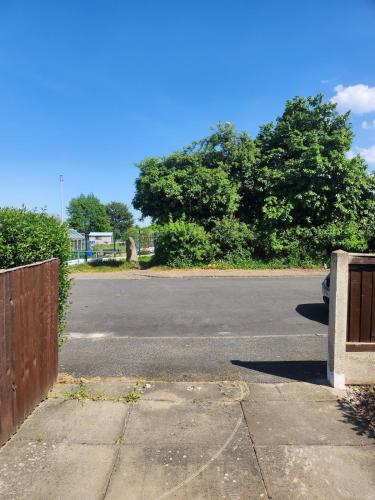 an empty parking lot with a car parked on the street at Spacious, 3 double bedroomed, free parking, 9 mins Elland Rd, nr Leeds City Centre in Leeds