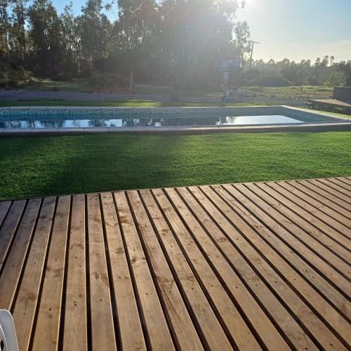 a view of a swimming pool with a wooden deck at Domo Tunquen in Tunquen