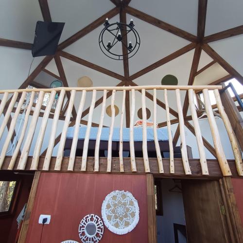 a wooden staircase in a room with a ceiling at Domo Tunquen in Tunquen