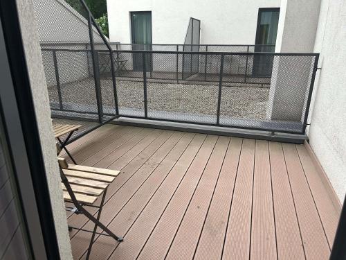 a balcony with a railing and two chairs on a deck at ibis Styles Bucharest City Center in Bucharest