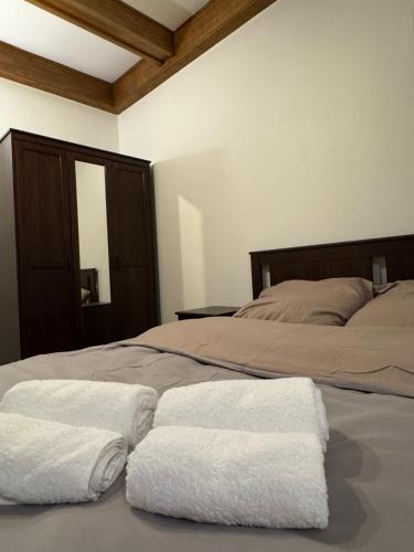 a bedroom with two white towels on a bed at Hotel Familiar in Kobyłka