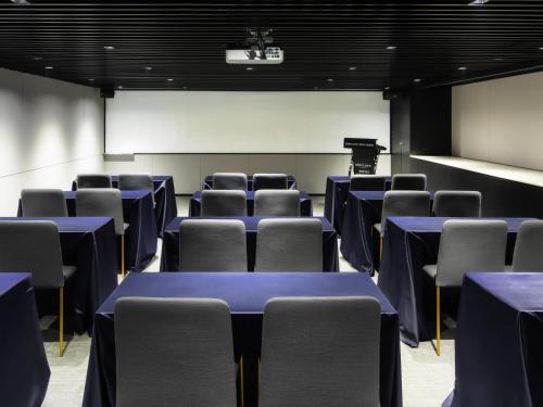a conference room with blue tables and chairs at Mercure Ambassador Seoul Hongdae in Seoul