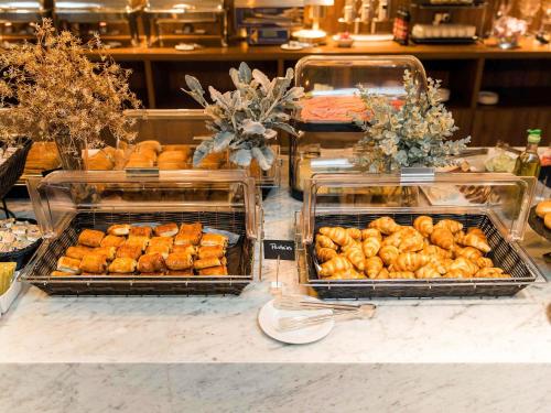 a buffet with trays of food on a table at Mercure St. Julian's Malta in St Julian's