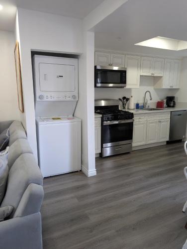 a kitchen with white cabinets and a white refrigerator at Modern 2BR Condo with King Bed & Balcony near LA in Alhambra