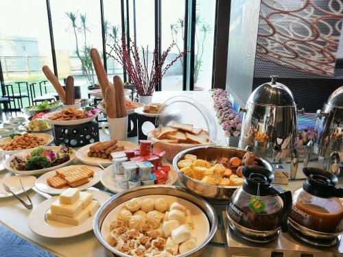 a table with many different types of food on it at Mercure Xiamen Zhongshan Road Pedestrian Street Seaview in Xiamen