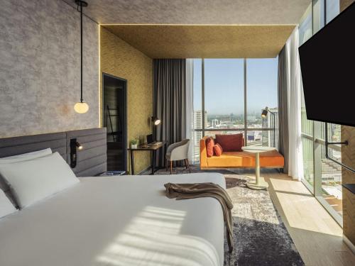 a hotel room with a bed and a balcony at Novotel Mexico City Toreo in Mexico City