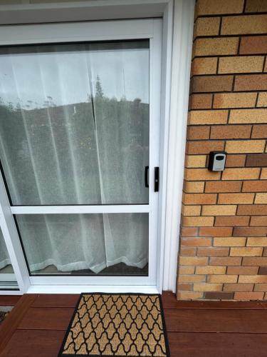 a front door of a house with a window at Coastal Comfort in Mount Maunganui