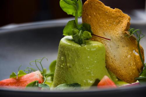 a plate with a sandwich and a piece of bread at Chateau La Chaire in Rozel