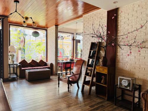 a living room with a couch and a chair at Cat Cat View Hotel in Sa Pa