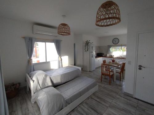 a bedroom with a bed and a kitchen with a table at Casa con Jardín Las Marías 2 in Miramar