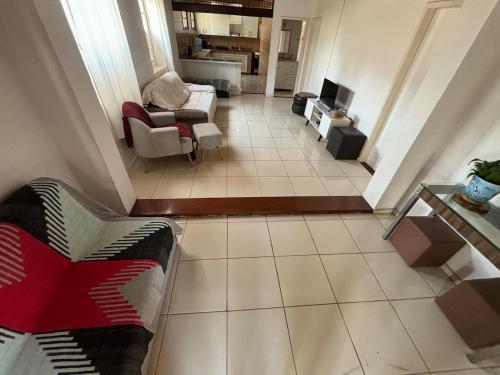 a view of a living room with a couch and chairs at Casa no centro de Miguel Pereira! in Miguel Pereira