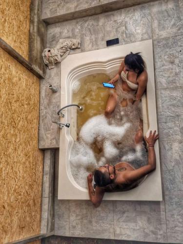 a picture of a man in a bath tub at Glamping el Porvenir RNT 10601 in Manta