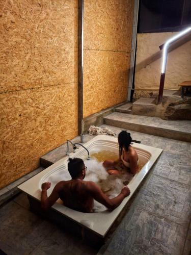 a man and a woman sitting in a bath tub at Glamping el Porvenir RNT 10601 in Manta