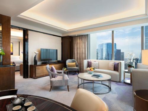 a living room with a couch and a table at Fairmont Chengdu in Chengdu