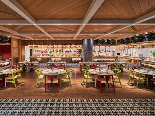 a restaurant with tables and chairs and a bar at Fairmont Chengdu in Chengdu