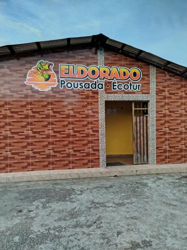 a building with a sign on the side of it at EL DORADO POUSADA in Barcelos