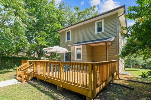 a house with a large deck with an umbrella at Walk to the stadium, downtown, West St - close to everything in Annapolis