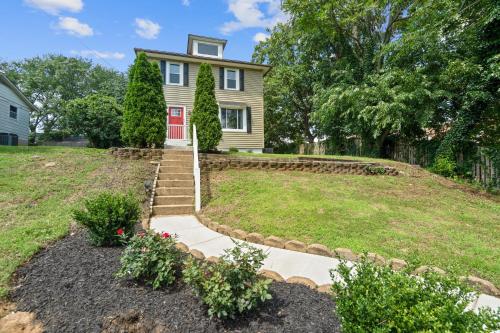 a house with a red door and a yard at Walk to the stadium, downtown, West St - close to everything in Annapolis