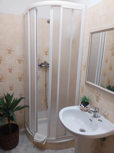 a bathroom with a shower and a sink at Seia Flat Mountain Seia View in Seia