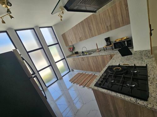 a kitchen with a stove and a counter top at Modern House with Private Pool in Punta Cana in Punta Cana