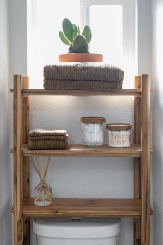 a wooden shelf above a toilet in a bathroom at Casita Calma Guesthouse Mins to DT & Airport in Phoenix